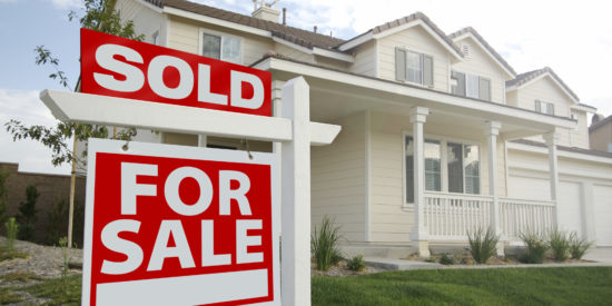 Sold Home For Sale Sign in front of Beautiful New Home.