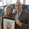 Robin and Jack Salzman with a plaque from Big Day at the Lake