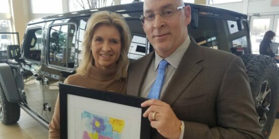 Robin and Jack Salzman with a plaque from Big Day at the Lake