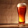 Full glass of freshness beer with foam on table against gray canvas background
** Note: Shallow depth of field