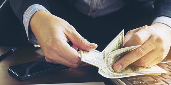 Business man counting dollar banknote - online business concept