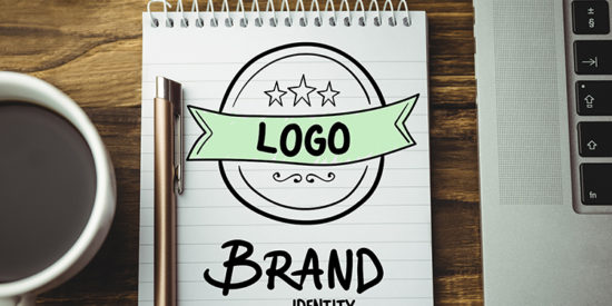 Composite image of laptop, notebook and coffee on a desk