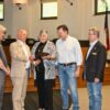 Deborah Young receives the Chamber award from Mayor Woody Washam as, (l-r) Bill Russell, husband Rick, Michael Osborne and Colin Furcht look on