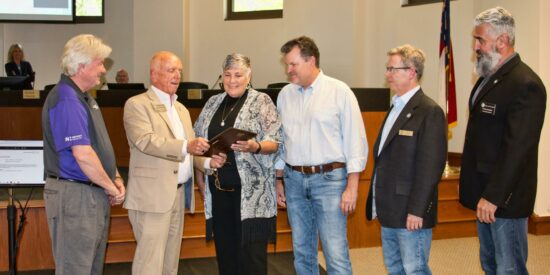 Deborah Young lands small business award from LKN Chamber Deborah Young receives the Chamber award from Mayor Woody Washam as, (l-r) Bill Russell, husband Rick, Michael Osborne and Colin Furcht look on