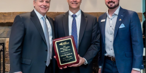 Joel Olsen receives Business Person of the Year award from 2023 LKN Chamber Chair Douglas Marion and Bobby Cashion representing the Cashion family. The award is named for the late Robert T. Cashion. Photo: John McHugh / Ocaid Photography